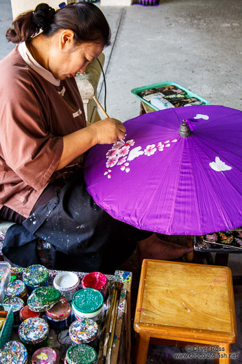 Woman painting a parasol at the Bo Sang parasol factory