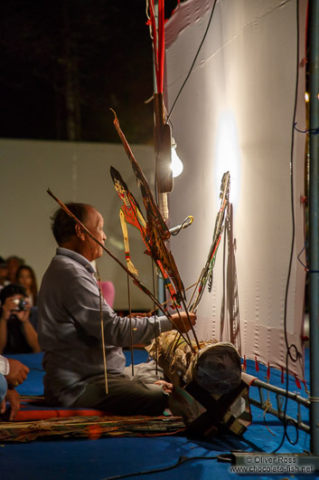 Behind the scenes view of a shadow puppet performance in Trang