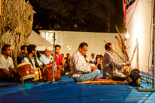 Behind the scenes view of a shadow puppet performance in Trang