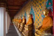 Travel photography:Row of golden Buddhas inside Bangkok´s Wat Arun , Thailand