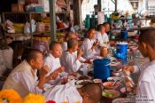 Travel photography:Female monks having lunch at Bangkok´s Wat Chana Songkram, Thailand