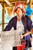 Travel photography:Woman with her loom at the Ban Lorcha Akha village, Thailand