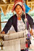 Travel photography:Woman with her loom at the Ban Lorcha Akha village, Thailand