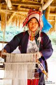 Travel photography:Woman with her loom at the Ban Lorcha Akha village, Thailand
