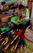 Travel photography:Woman assembling parasols at the Bo Sang parasol factory, Thailand