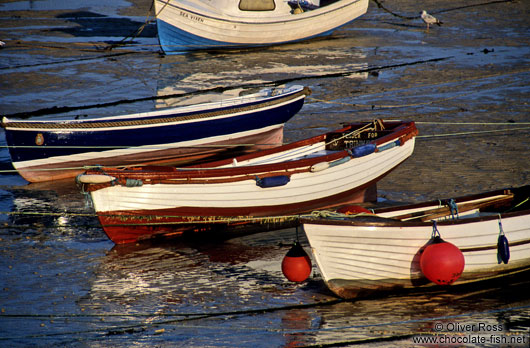 Small rowing boats in a Cornwall harbour at low tide