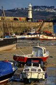 Travel photography:Fishing harbour and lighthouse in Cornwall, United Kingdom England