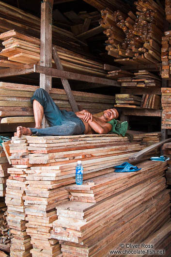 Man sleeping in a wood shop in Danang