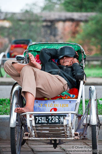 Hue ricksha driver having a nap