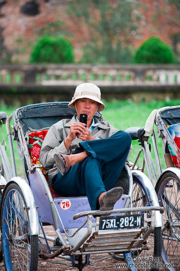 Hue ricksha driver with mobile phone