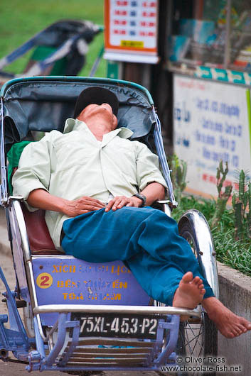 Sleeping ricksha driver in Hue