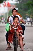 Travel photography:Kids riding a bike in Hue, Vietnam