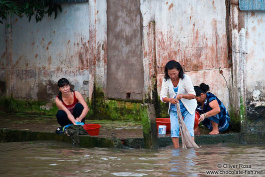 Women doing their laundry in the river at Can Tho 