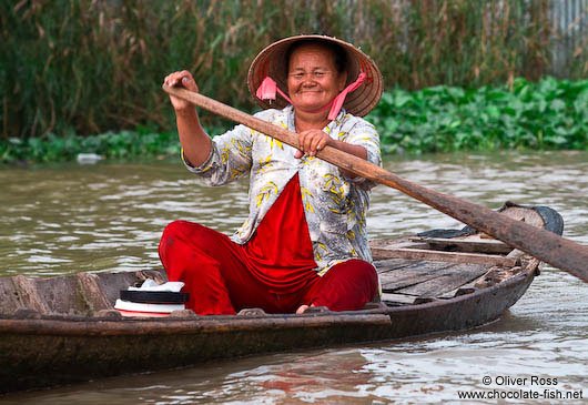 Woman paddling her boat near Can Tho 