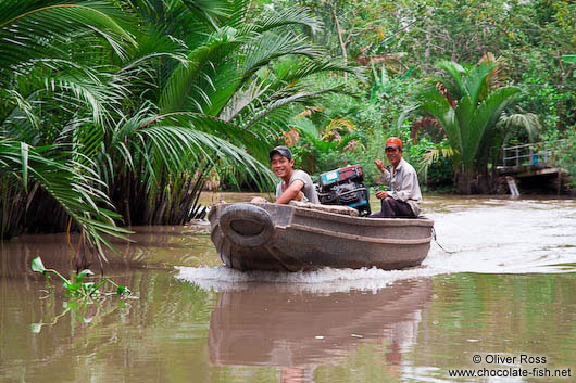 Boat cruising a Mekong tributary near Can Tho 