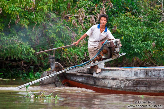 Boy driving a boat near Can Tho 