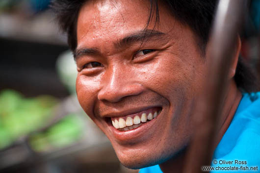 Happy food vendor at the Can Tho floating market 