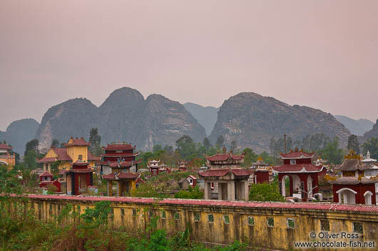 Graves with characteristic karst mountains near Ninh Binh