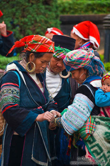 Hmong women examining their handy work at the weekly market in Sapa 