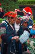 Travel photography:Hmong women examining their handy work at the weekly market in Sapa , Vietnam