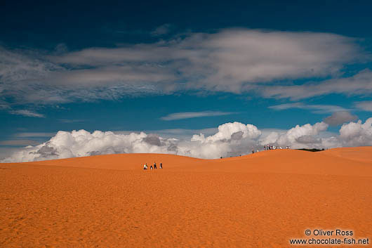 People walking through the giant red sand dunes near Mui Ne 