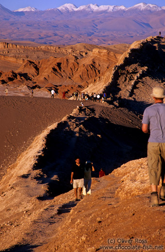 People walking on sand dune near the Valley de la Luna, San Pedro de Atacama